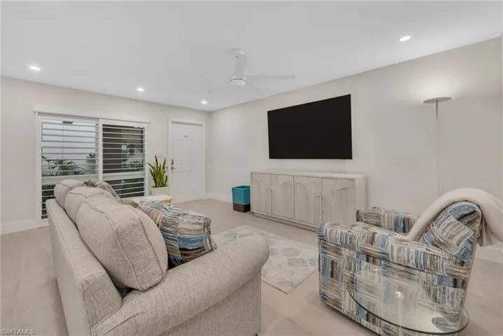 Living area featuring a ceiling fan, recessed lighting, and light wood-style floors