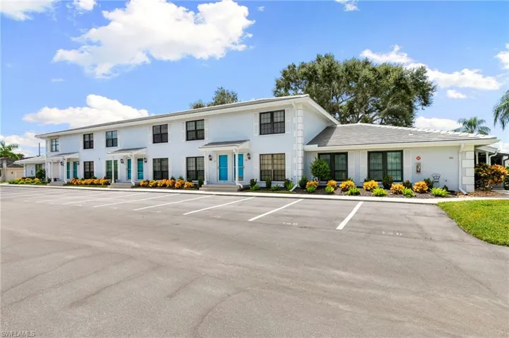 View of building exterior with two assigned parking spaces in front of  home!