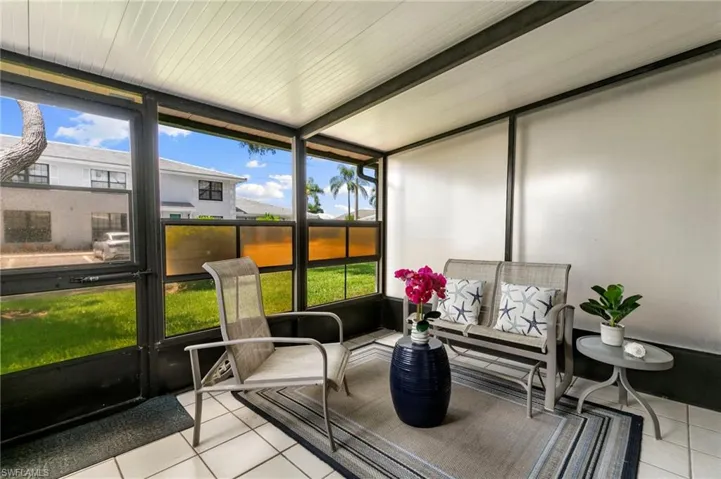 Sunroom/solarium with beamed ceiling