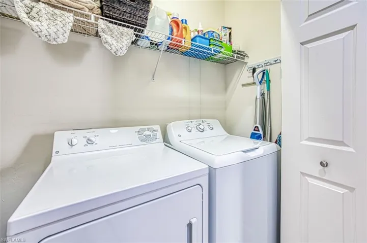 Clothes washing area featuring washing machine and clothes dryer