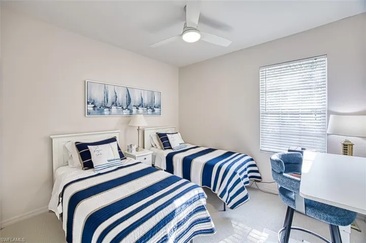 Carpeted bedroom featuring baseboards and a ceiling fan
