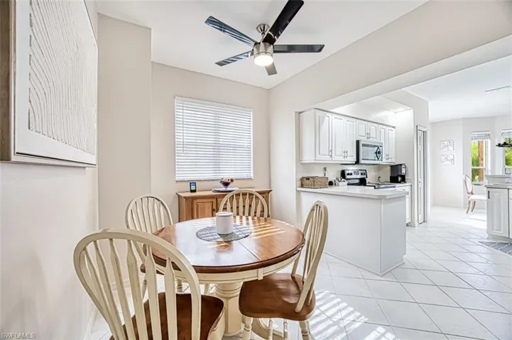 Dining room featuring light tile patterned floors and ceiling fan