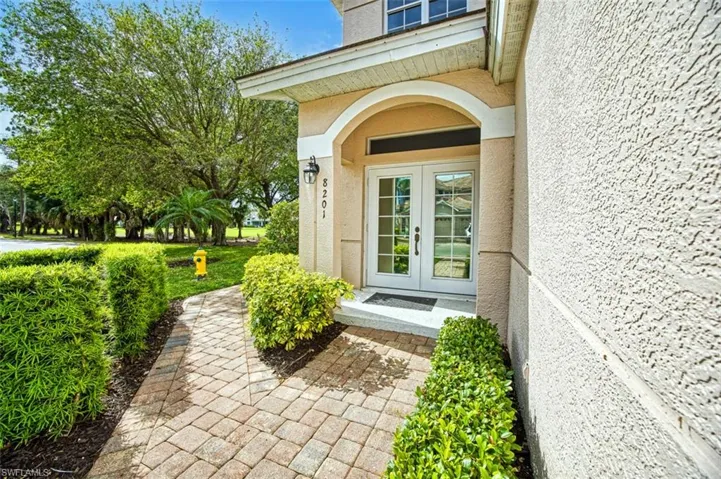 Doorway to property featuring french doors and stucco siding