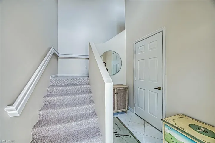 Staircase featuring tile patterned flooring and baseboards