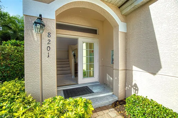 Property entrance featuring stucco siding