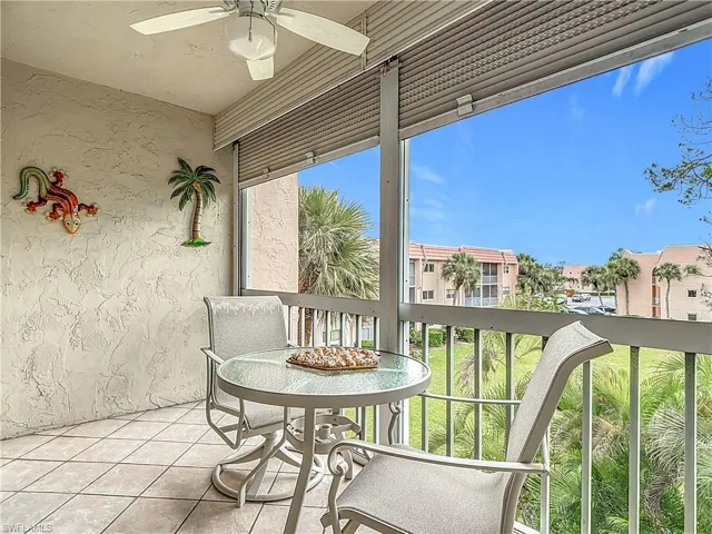 Balcony featuring ceiling fan and a residential view