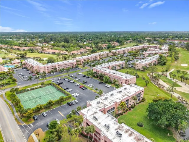 Bird's eye view of apartment complex / building and a golf course