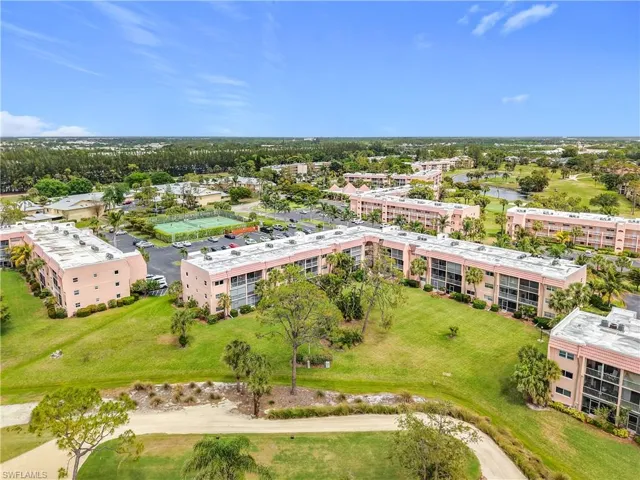 Bird's eye view of apartment complex and a nearby body of water