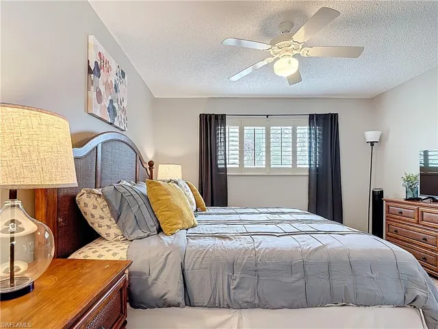 Bedroom featuring a textured ceiling and ceiling fan