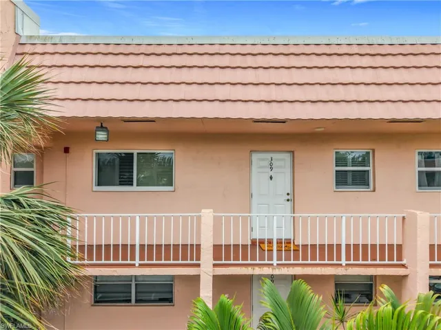 View of front of property with stucco siding and a tile roof