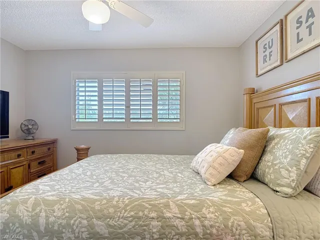 Bedroom featuring a textured ceiling and a ceiling fan