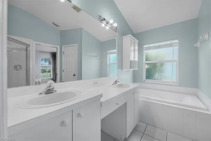 Double vanity with white cabinetry and integrated sinks