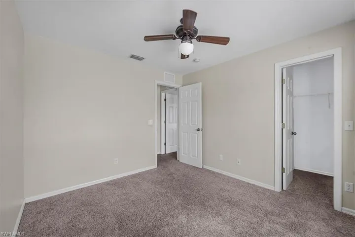 Neutral tone walls with brown carpet flooring