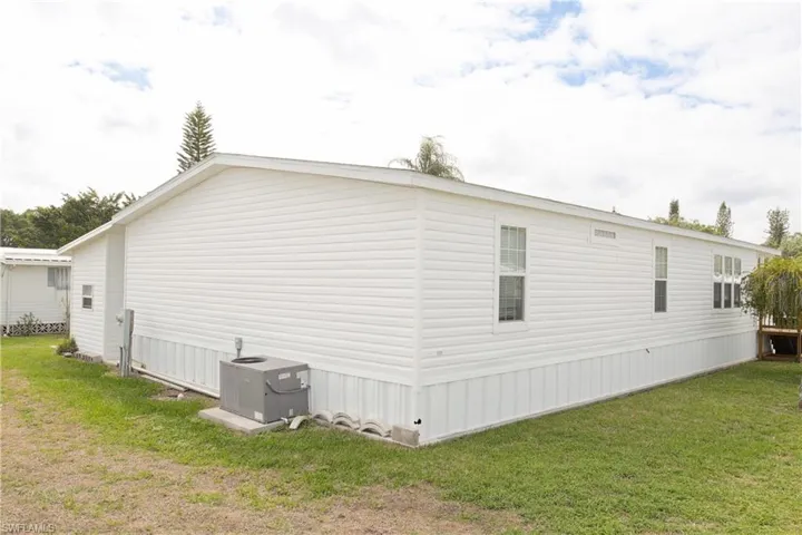 View of home's exterior featuring a yard and a central air condition unit
