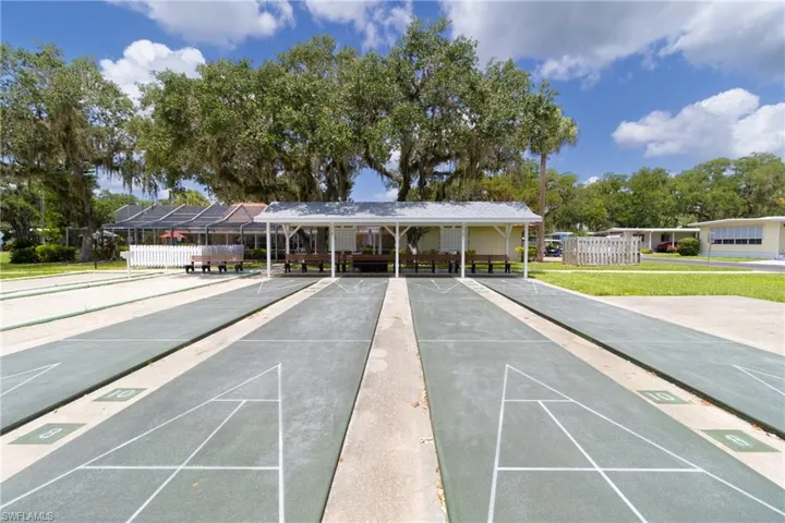 View of home's community with shuffleboard