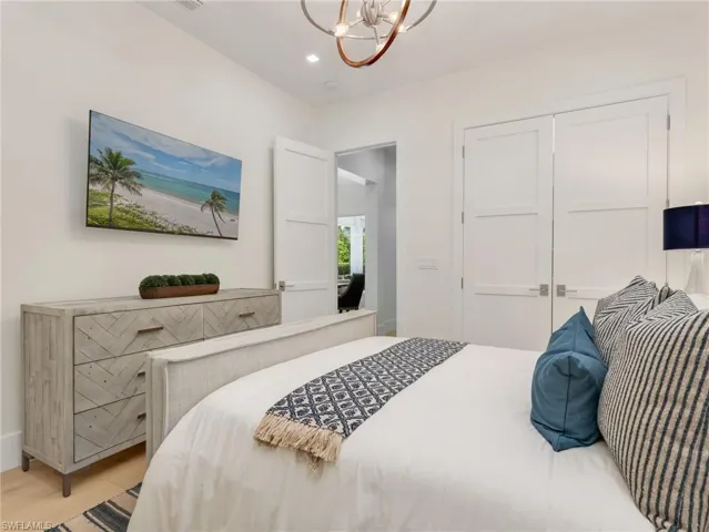 Recessed lighting, wood-finish flooring, and white paneled doors with brushed nickel hardware