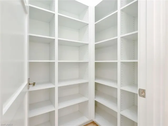 Corner built-in shelving with adjustable shelves and a light finish