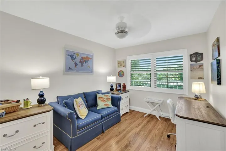 Home office with light wood-style floors and ceiling fan