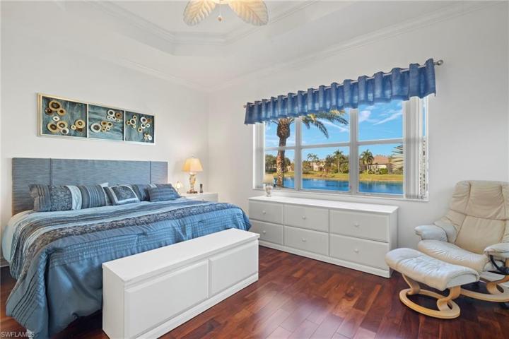 One of two master bedrooms. Featuring a view of landscaping and the lake.