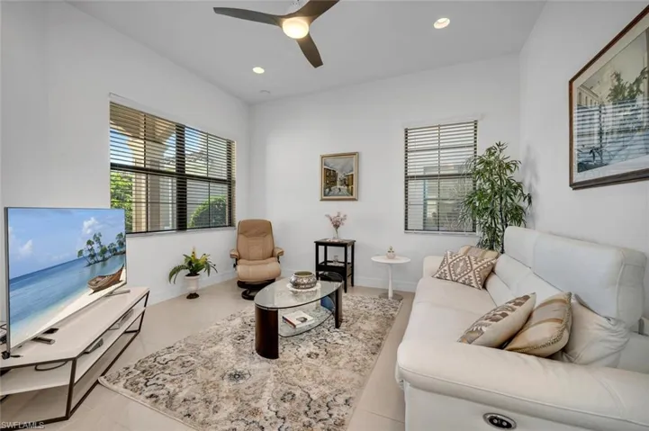 Tiled living room featuring ceiling fan