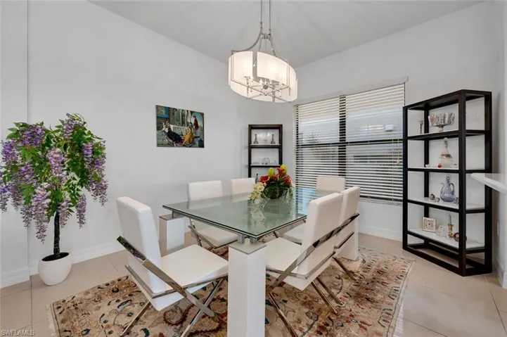 Tiled dining space with a chandelier