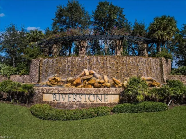 Community / neighborhood sign featuring a yard
