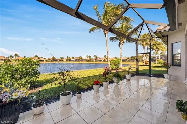 View of patio featuring a lanai and a water view