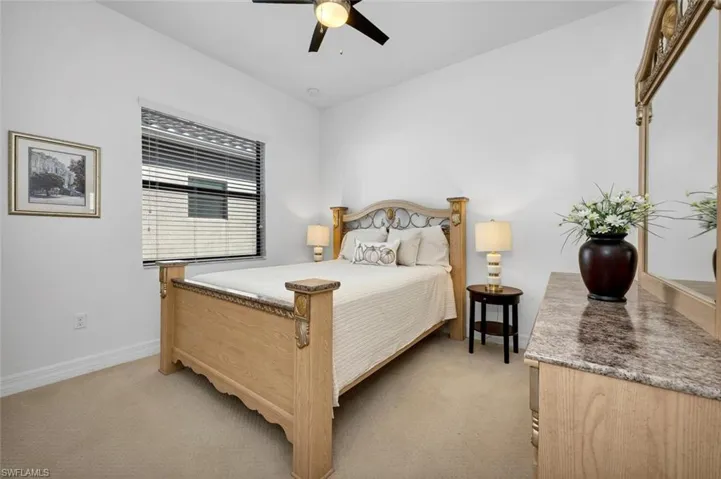 Bedroom featuring light colored carpet and ceiling fan