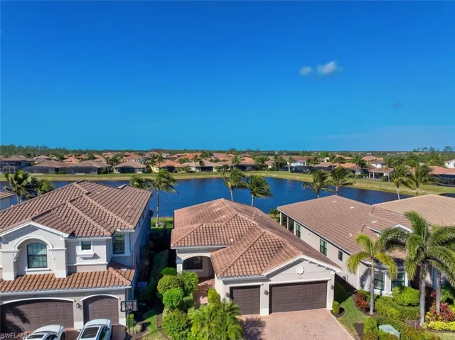 Birds eye view of property with a water view