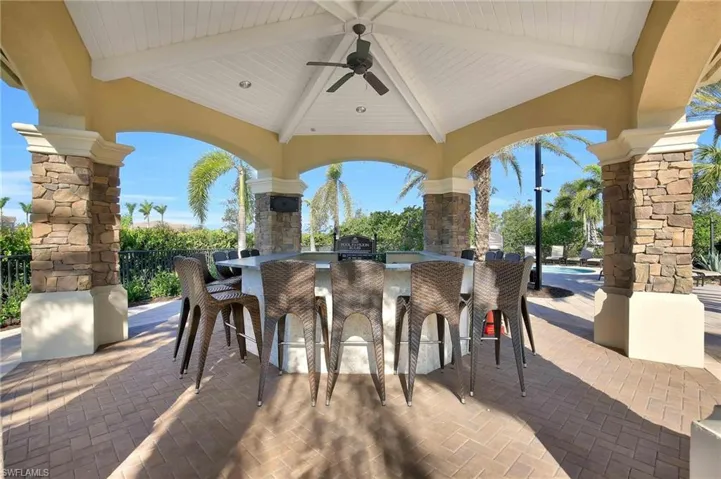 View of patio with ceiling fan, a gazebo, a bar, and grilling area