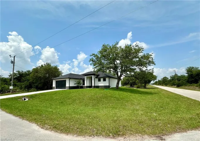 View of front facade with a front lawn and a garage