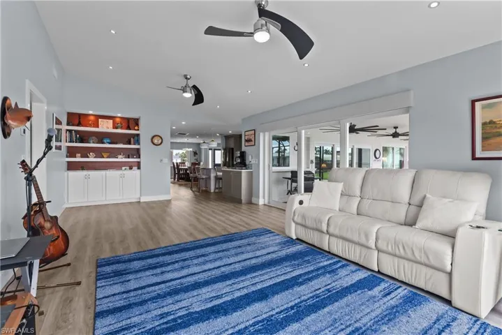 Living room with hardwood / wood-style flooring and lofted ceiling