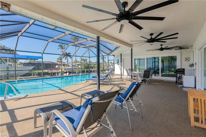 View of swimming pool featuring a patio area and a lanai