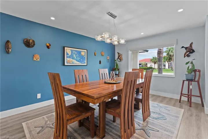 Dining room featuring a notable chandelier and light wood-type flooring