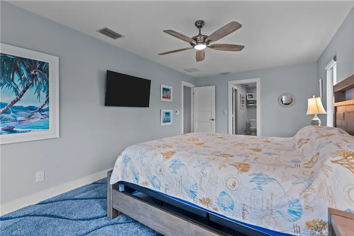 Carpeted bedroom with ceiling fan