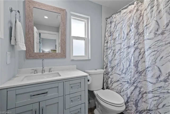 Bathroom with vanity, toilet, and walk in shower
