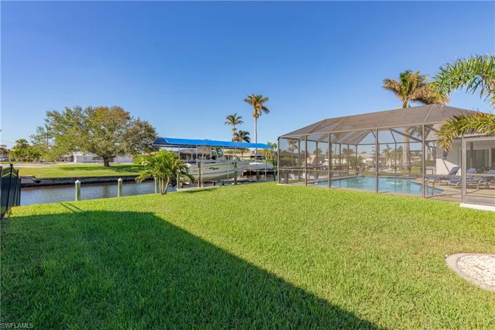 View of yard featuring a lanai and a water view