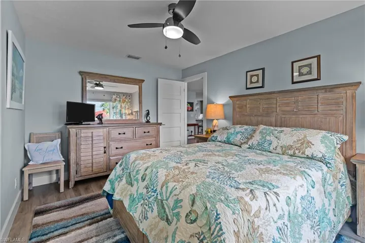 Bedroom with ceiling fan and dark hardwood / wood-style floors