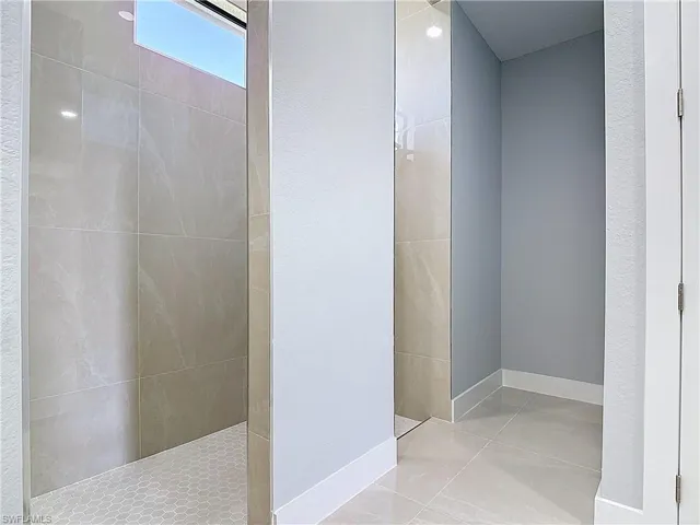 Bathroom with baseboards and a walk in shower