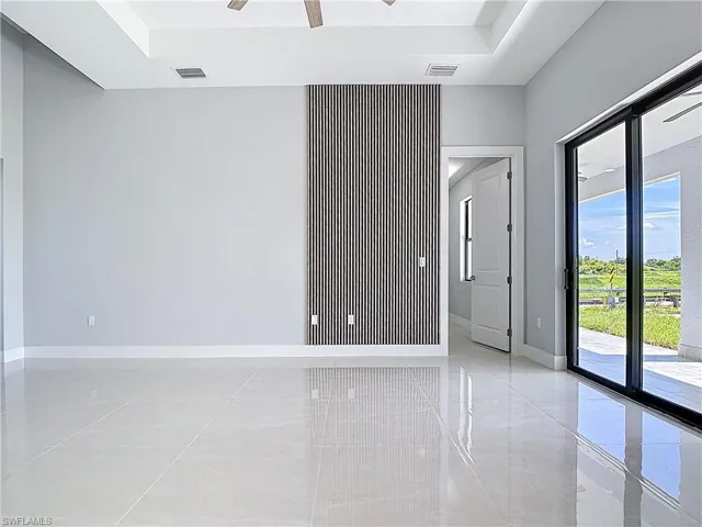 Unfurnished room with baseboards and ceiling fan