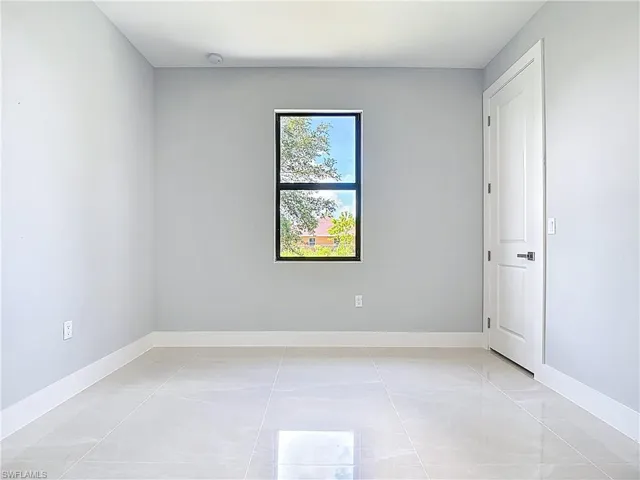 Spare room featuring baseboards