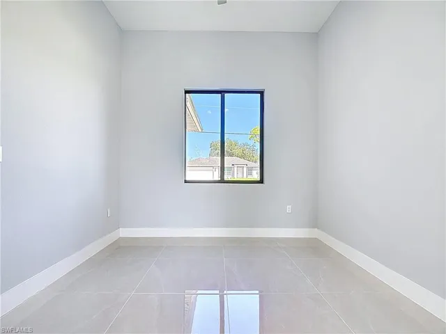 Unfurnished room featuring baseboards