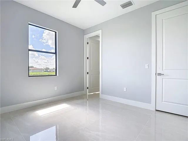 Unfurnished bedroom with baseboards and a ceiling fan