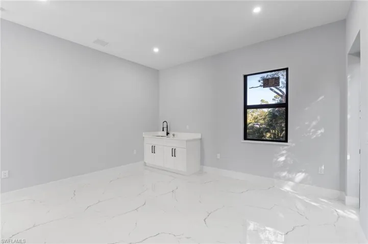 Unfurnished room with recessed lighting and light marble finish floors