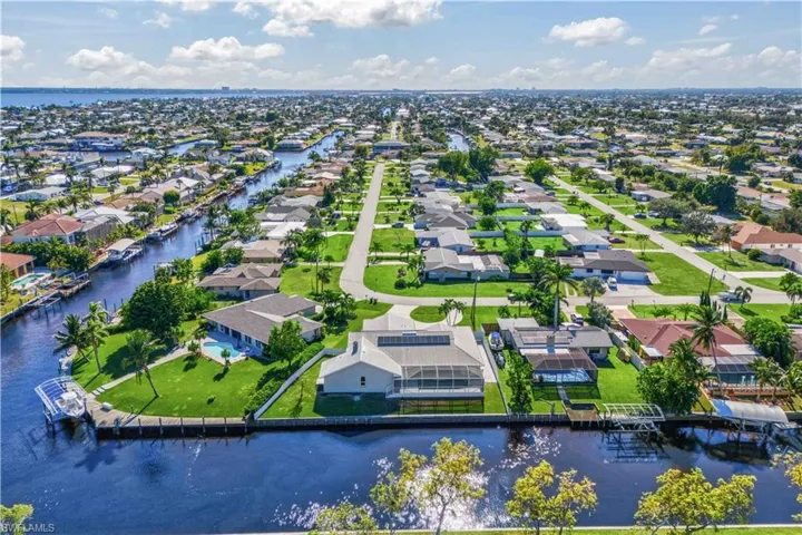 Birds eye view of property with a water view