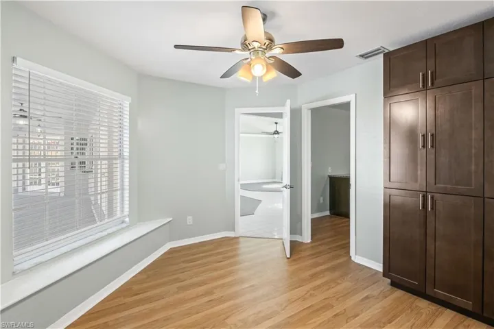 Unfurnished bedroom with ceiling fan and light hardwood / wood-style flooring