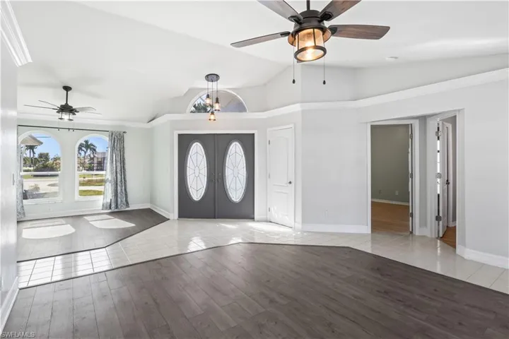 Entryway featuring french doors, light hardwood / wood-style flooring, vaulted ceiling, and ceiling fan