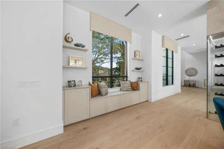 Sitting room featuring light wood-type flooring, baseboards, visible vents, and recessed lighting