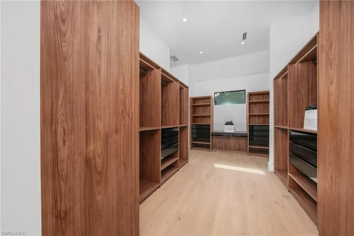 Walk in closet featuring visible vents and light wood-style flooring
