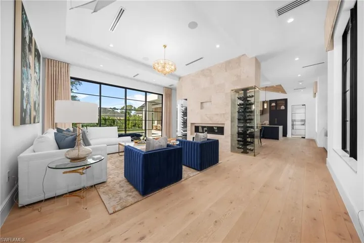 Living room featuring visible vents, a tile fireplace, wood finished floors, a chandelier, and recessed lighting
